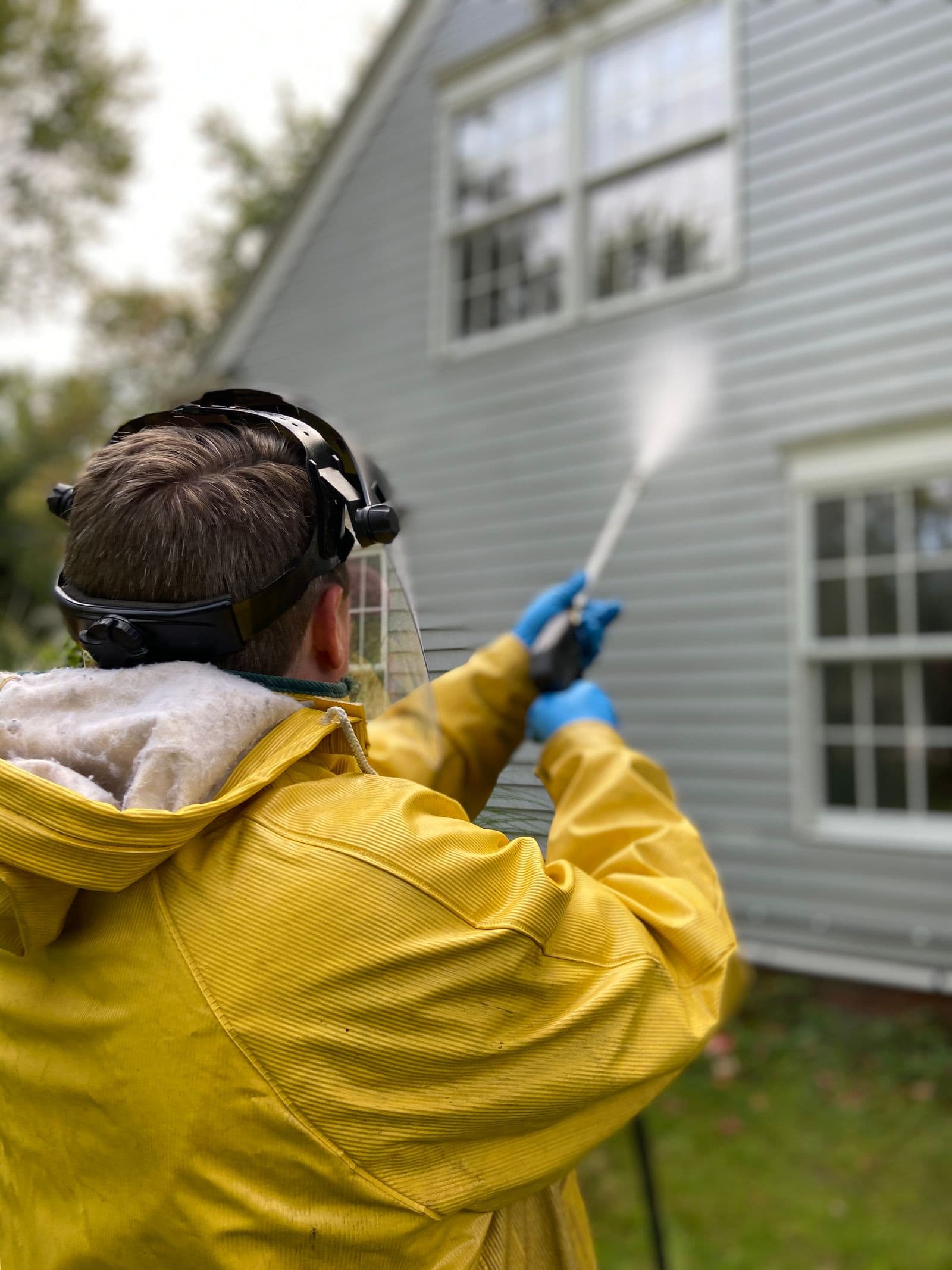 A worker pressure washing home siding in the fictional Gulf Pine website preview